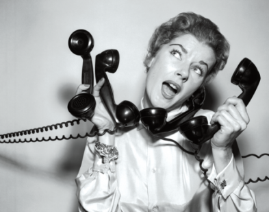 Woman answering multipe phones black and white